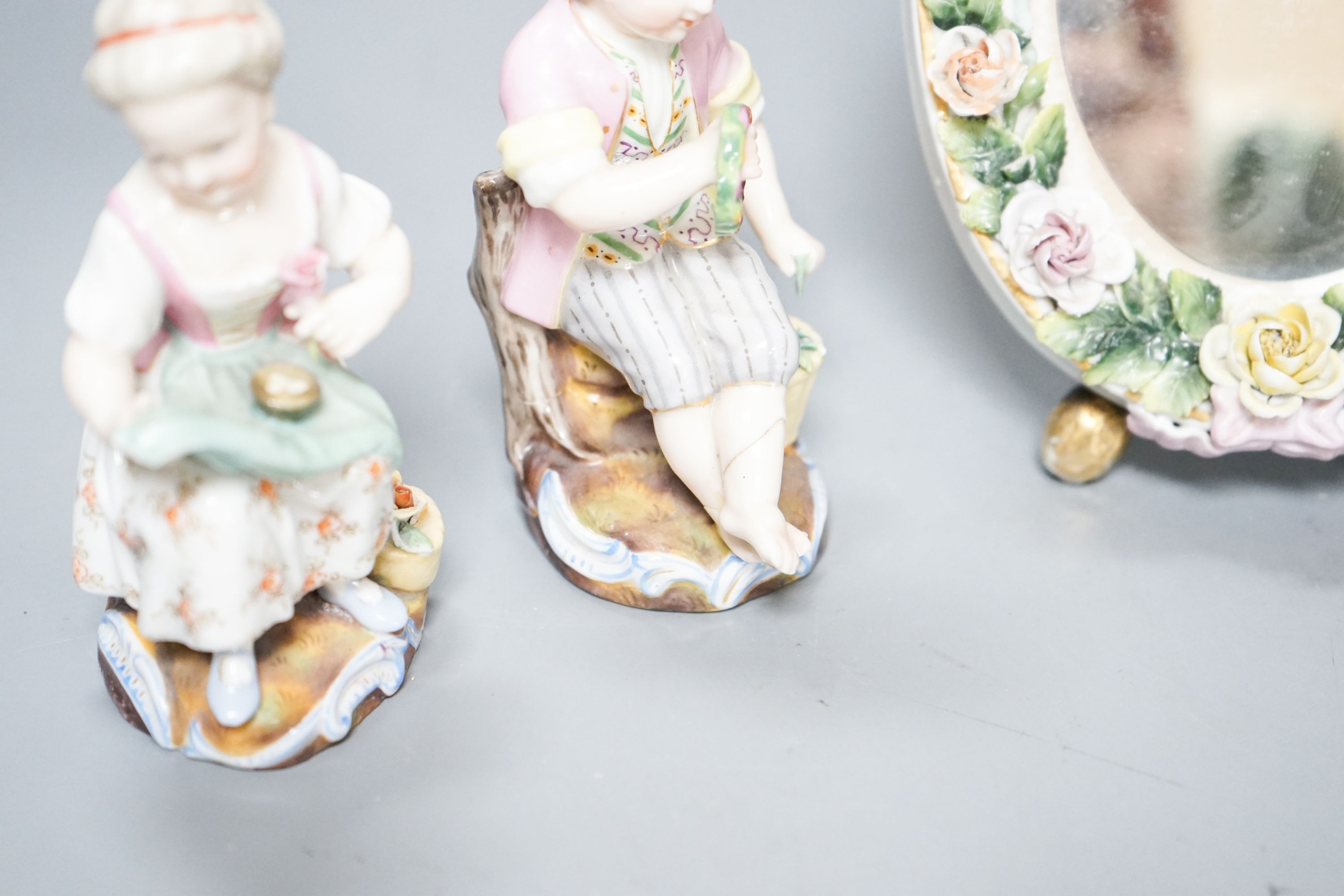 A pair of Meissen groups holding chickens, 10.5cm, a pair of Sitzendorph figures and a Sitzendorf mirror 18cm